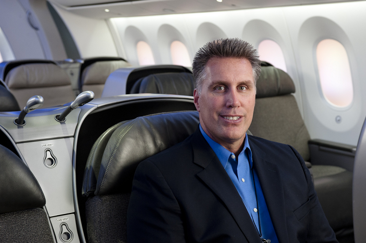 A man sitting on the back of an airplane.